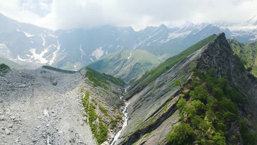 4K Aerial shot of beautiful Himalaya mountains with small river stream flowing from Beas Kund in Himachal Pradesh, India. Summer landscape. Travel and holidays background.
