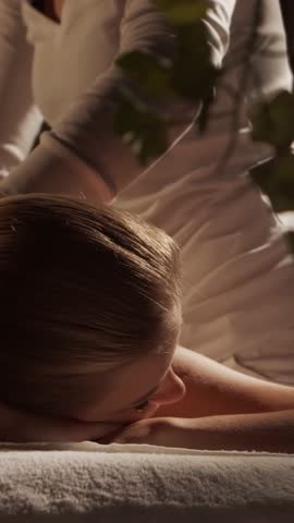 Woman is getting massage treatment from the therapist. Massaging procedure in spa. Healthcare, relaxation, rejuvenation and wellness concept.
