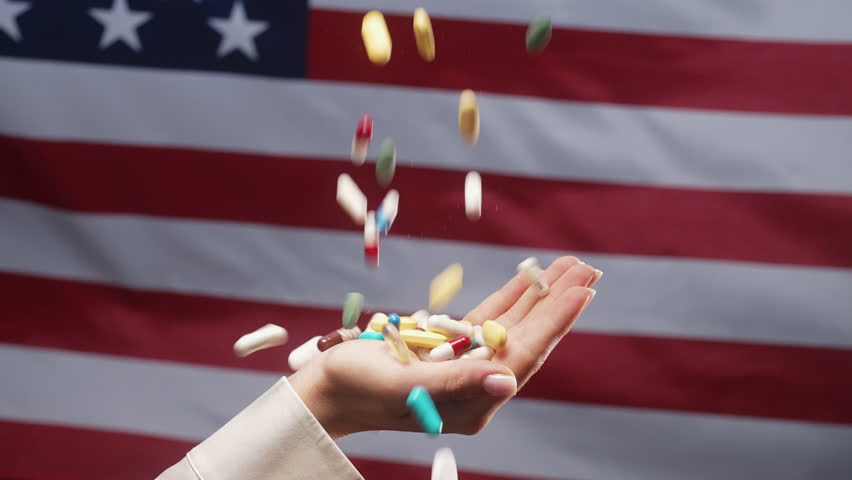 Pills Falling On Female Hand On usa Flag. Expensive Medication In United states