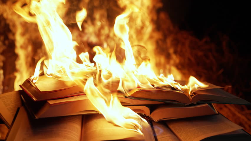 Open book is on fire, pages are engulfed in flames. Concept of censorship, prohibition of freedom information, 451 fahrenheit, old literature in paper format is no longer in demand. 