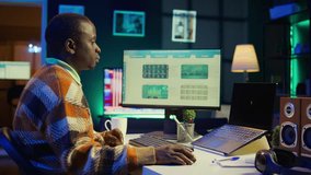 African American man having discussion during online meeting on laptop, talking about internet statistics or data. Freelancer use technology for virtual communication, working remotely. Camera B. - Powered by Shutterstock - Get 15% off with code: PIKWIZARD15