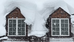 CLOSE UP: Snowflakes fall past the windows of a cabin in the picturesque wintry Japanese mountains. Rustic cottage in Niseko, Japan gets covered in blanket of fresh powder snow on a cold February day. - Powered by Shutterstock - Get 15% off with code: PIKWIZARD15