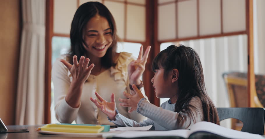 High five, homework and Asian mother with child in home for learning, teaching and maths lesson. Family, success and happy Japanese mom and girl help with education, counting and school project