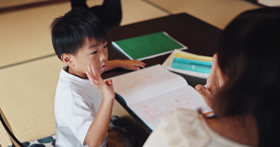 Homework, counting and Asian child with mom in home for maths lesson, learning and teaching. Japanese family, education and kid with books, tutor and fingers for numbers, studying and development