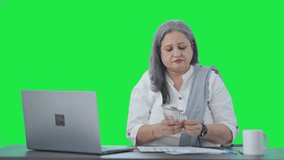 Cheerful Indian senior businesswoman counting money Green screen - Powered by Shutterstock - Get 15% off with code: PIKWIZARD15