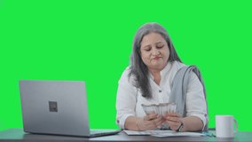 Happy Indian senior businesswoman counting money Green screen - Powered by Shutterstock - Get 15% off with code: PIKWIZARD15