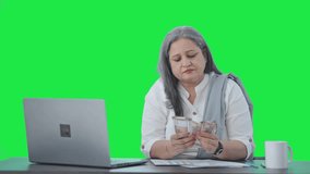 Indian senior businesswoman counting money Green screen - Powered by Shutterstock - Get 15% off with code: PIKWIZARD15