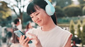 Asian woman, headphones and phone for music in city, online and scroll on social media in Japan. Female person, laughing and funny meme on internet for humor, hearing sound and comic podcast in town - Powered by Shutterstock - Get 15% off with code: PIKWIZARD15