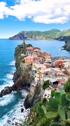 Experience the breathtaking views of colorful houses perched on cliffs overlooking the azure sea. This charming village in Vernazza Italy in Cinque Terre
