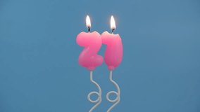Pink air balloon shaped birthday candles burning on blue background. Number 21. - Powered by Shutterstock - Get 15% off with code: PIKWIZARD15