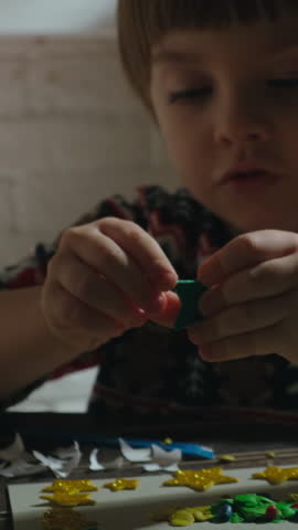 Vertical video. Child makes special DIY Christmas holiday cards for family members