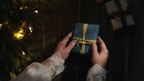 Female hands unwrapping Christmas present - Powered by Shutterstock - Get 15% off with code: PIKWIZARD15