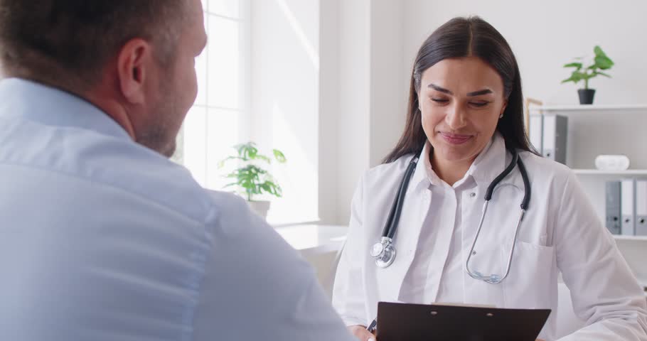 Female doctor or nurse holds a medical appointment with a patient in a hospital office visit. The healthcare provider offers medical care, support, and guidance to ensure the patient well-being.