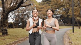 Asian women, fitness and running with water at park for workout, cardio exercise or training in nature. Active friends, japanese runner or female people with smile for health and wellness on path - Powered by Shutterstock - Get 15% off with code: PIKWIZARD15