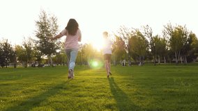 mother son playing rugby ball in the park. mother catching up with son. child running with ball. fun games in evening park. concept happy - Powered by Shutterstock - Get 15% off with code: PIKWIZARD15