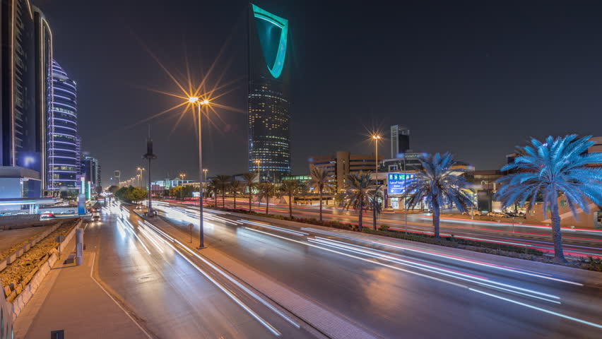 Panoramic aerial night timelapse of Riyadh featuring highway traffic, Kingdom Tower the tallest skyscraper and landmark of Saudi Arabia's capital. Illuminated modern buildings surround vibrant scene
