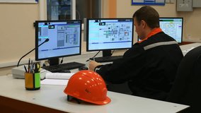 Operator at plant control panel monitors parameters of equipment at plant. Innovative Safety Solutions specifically designed for Modern Workspaces, aiming to enhance both operational Efficiency - Powered by Shutterstock - Get 15% off with code: PIKWIZARD15