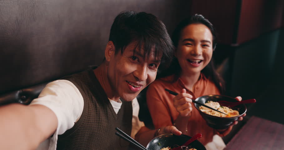 Couple, face and selfie with food in restaurant, bonding and celebration for anniversary with smile. Japanese people, man and woman in portrait with photography, picture and romantic with noodles