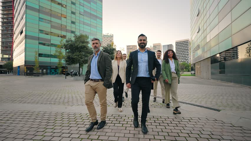 Group of successful company professionals walking in the city. Business People Team together with confidence and determination towards their goal