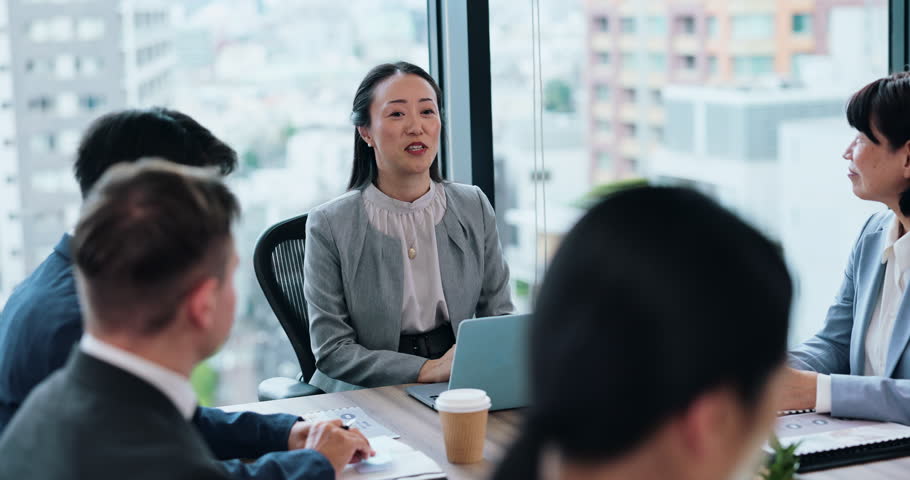 Japanese business people, team leader and talking in meeting, ideas or planning on laptop in boardroom. Group, collaboration or discussion with project manager for sales report or training in office