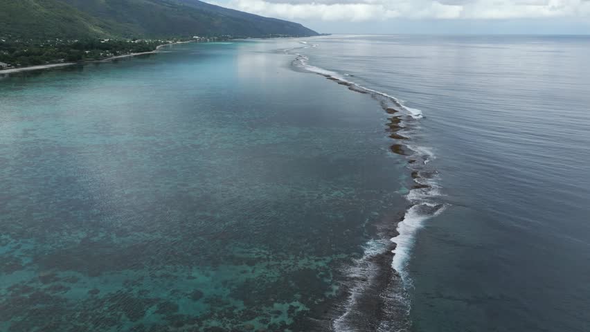 Lagoon And Coral Reefs Of Plage Vaiava In Puna'auia, French Polynesia. Aerial Drone Shot