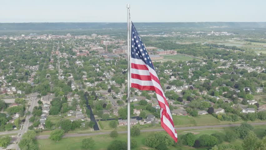 Aerial view of Grandad Bluff with city of La Crosse at background and American flag waving high in the Mississippi River Valley, Wisconsin of USA.