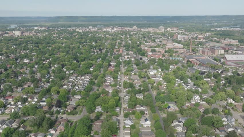 High angle shot of La Crosse city in Wisconsin, USA. Surrounded in greenery. Drone.