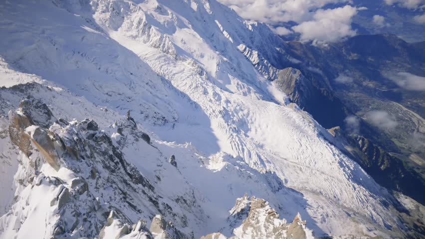 On the ascent, enjoy a stunning view of Mont Blanc and the Comisques Ridge, with rugged terrain and sweeping vistas of the surrounding alpine landscape.