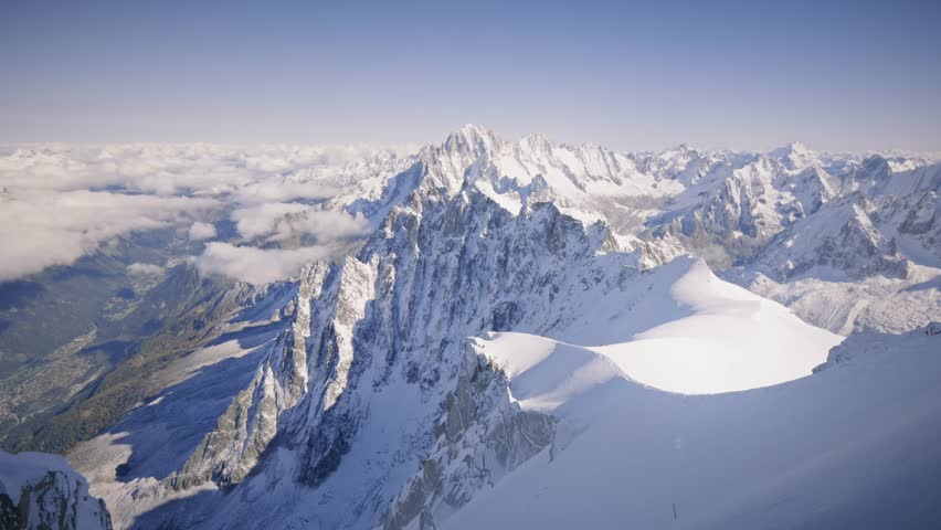 The view of the Mont Blanc Massif and the Chamonix Valley offers a breathtaking panorama, with towering peaks, glaciers, and the picturesque valley below, surrounded by dramatic alpine beauty.