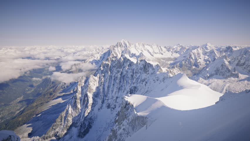 The view of the Mont Blanc Massif and the Chamonix Valley offers a breathtaking panorama, with towering peaks, glaciers, and the picturesque valley below, surrounded by dramatic alpine beauty.