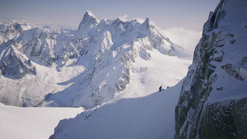 The Mont Blanc massif stretches in the background, with a mountaineer carrying skis on his back, ready to tackle the challenging terrain of this iconic alpine region.