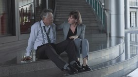 Senior businessman stressed about business results while being comforted by female employee - Powered by Shutterstock - Get 15% off with code: PIKWIZARD15