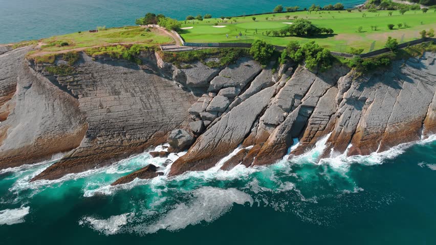 Golf course at Cabo Menor in Santander, Cantabria, northern Spain. Aerial view of the stunning golf fields on the peninsula, featuring rocky cliffs and scenic views of Santander city.