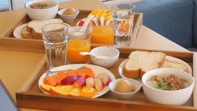 Healthy breakfast served on wooden trays with fresh fruits, orange juice, and toast, Enjoying nutritious morning meal at home, Balanced Diet and Healthy Living. - Powered by Shutterstock - Get 15% off with code: PIKWIZARD15