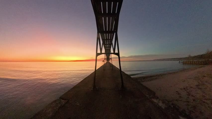 Interesting sunrise journey along the Catwalk at Sturgeon Bay Canal Pierhead Lighthouse in Door County Wisconsin on Lake Michigan.  Video speed is increased to 16x the normal speed.  