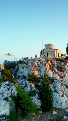 Profitis Ilias - drone flying up a small church with a stone facade located on a rocky hill in Protaras, Cyprus