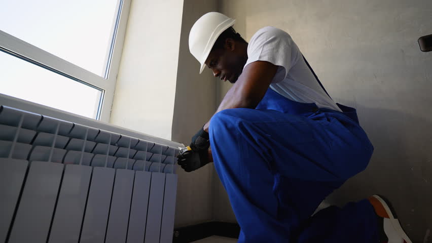 Technician Installing Radiator for Home Heating Efficiency