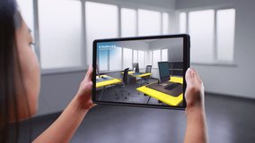 Asian female designer uses tablet computer and augmented reality interior design software to build office. Tablet screen shows AI builder app scanning room, creating design with 3D furniture objects. - Powered by Shutterstock - Get 15% off with code: PIKWIZARD15