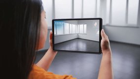 Asian female designer uses tablet computer and virtual reality interior design app to design office workspace. Tablet display shows AI builder software scanning and creating design with 3D furniture. - Powered by Shutterstock - Get 15% off with code: PIKWIZARD15