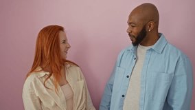 Interracial couple laughing together against pink background showcasing love and happiness in a relaxed atmosphere - Powered by Shutterstock - Get 15% off with code: PIKWIZARD15