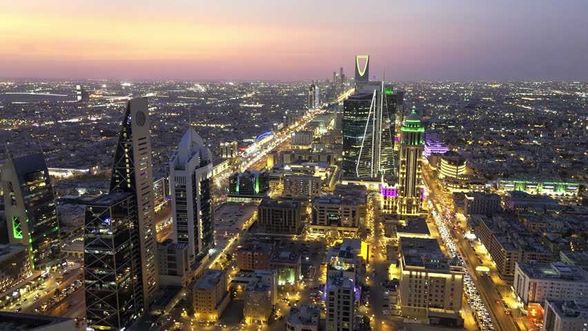 Al Faisaliah Tower pyramid-shaped commercial skyscraper. Riyadh. Drone shot flying. Sunset. Evening.