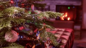 Beautifully decorated Christmas tree with colorful lights and ornaments near a glowing fireplace, creating a warm and cozy holiday atmosphere in the living room - Powered by Shutterstock - Get 15% off with code: PIKWIZARD15