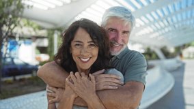 Middle-aged couple embracing outdoors in an urban street, showcasing love and happiness in a city setting with man and woman smiling together joyfully. - Powered by Shutterstock - Get 15% off with code: PIKWIZARD15