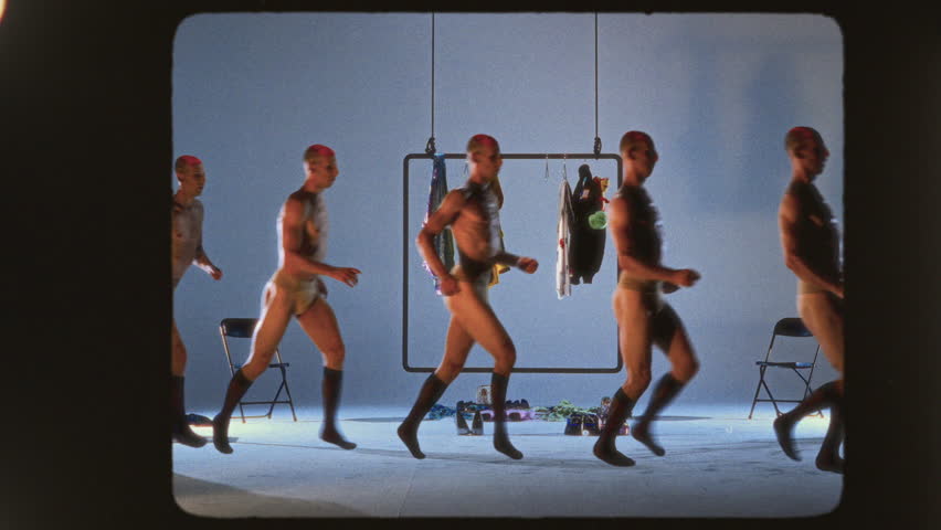 A mesmerizing performance featuring avant-garde artists adorned in vibrant bodysuits, enhanced by a stunning multiplier effect