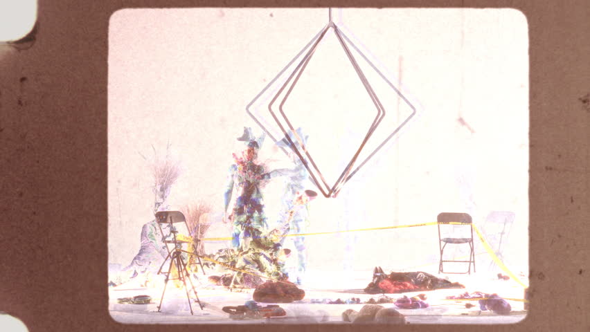 A stunning visual performance featuring avant-garde artists adorned in vibrant bodysuits and a hanging diamond metal structure, enhanced by a captivating multiplier effect