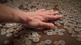 Gently and intentionally placing various coins on a surface of a table during a casual setting - Powered by Shutterstock - Get 15% off with code: PIKWIZARD15