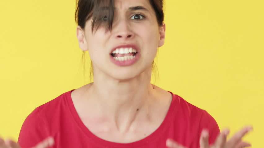 Feeling rage. Personal boundaries. Girl furious angry enraged fuming standing for herself isolated on yellow free space background.