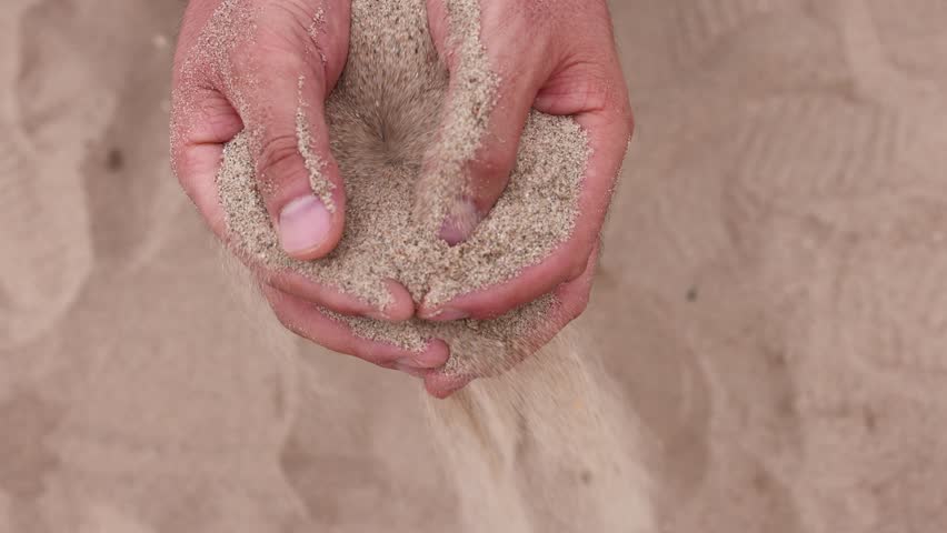 The sand slowly flows away from my hands