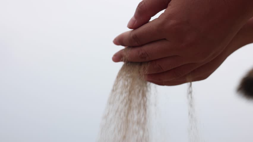 The sand slowly flows away from my hands