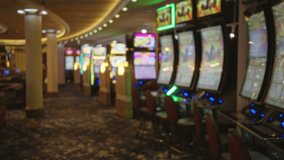 Colorful slot machines line a bustling casino floor in las vegas, with bright lights and an inviting atmosphere enhanced by vibrant carpets and ambient lighting. - Powered by Shutterstock - Get 15% off with code: PIKWIZARD15